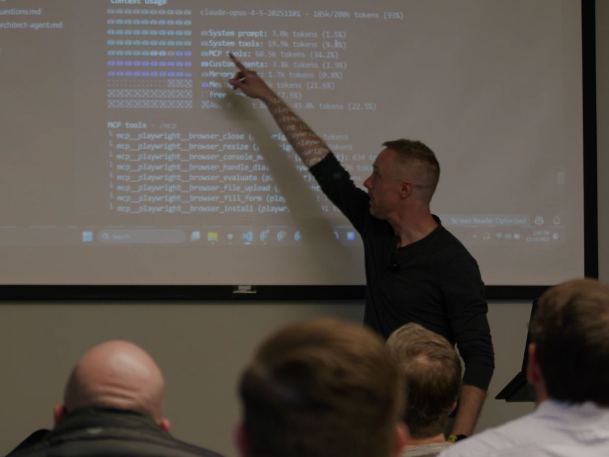 Austin pointing at screen during on-site corporate AI training