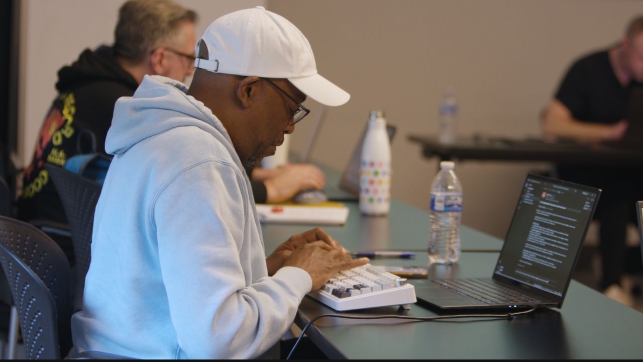 Student working on a mechanical keyboard during AI training